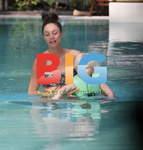 Sharlely Becker and son Amadeus playing in pool
