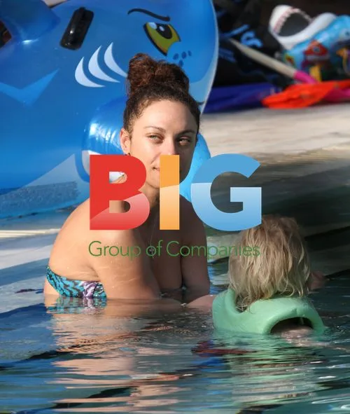 Sharlely Becker and Son Amadeus Playing in Pool