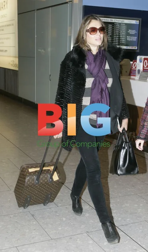 Elizabeth Hurley Arrives at Heathrow