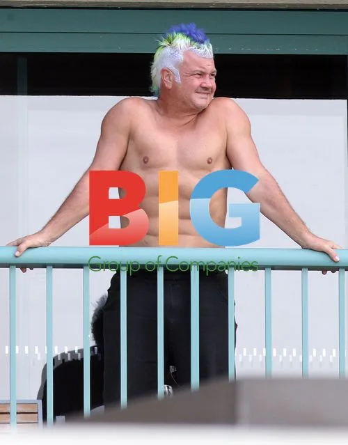 Darryn Lyons Shows Off Abs on Hotel Balcony