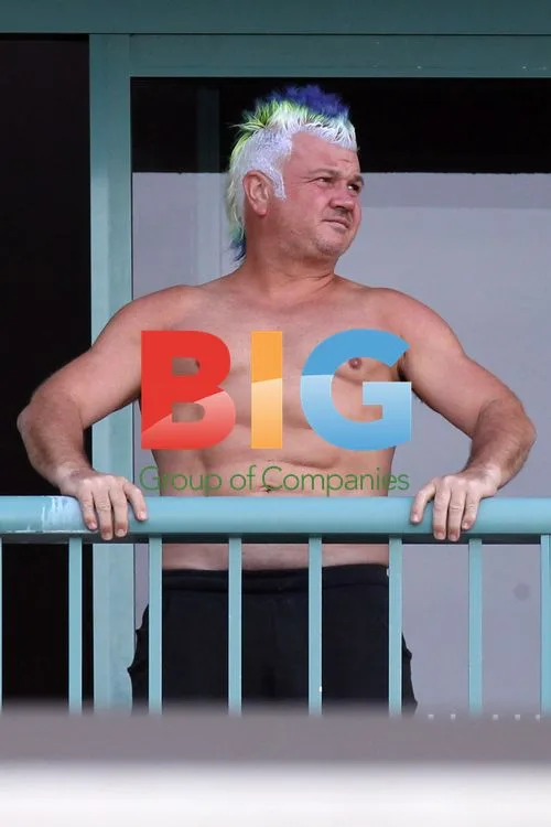 Darryn Lyons Shows Off Abs on Sydney Hotel Balcony