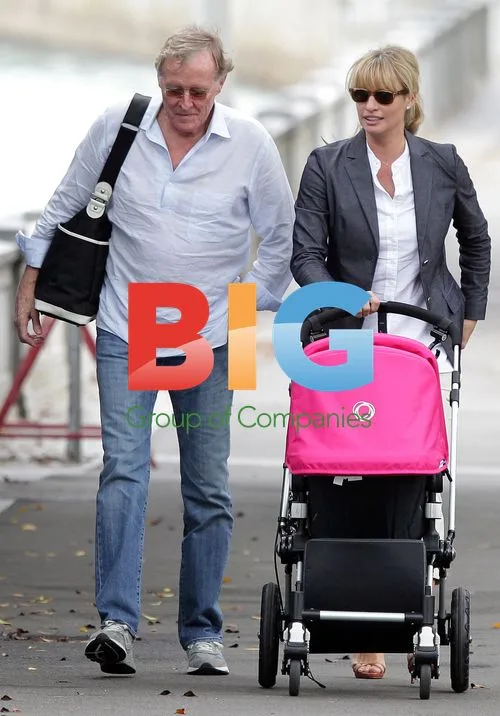 Kristy Hinze and family out with baby