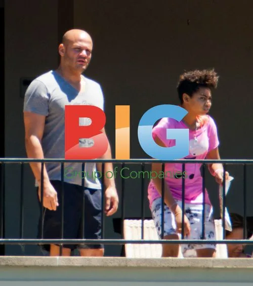 Melanie Brown with family on balcony