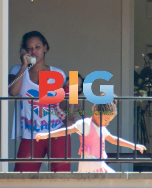 Melanie Brown with family on balcony