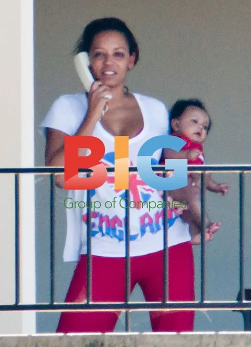 Melanie Brown with family on balcony