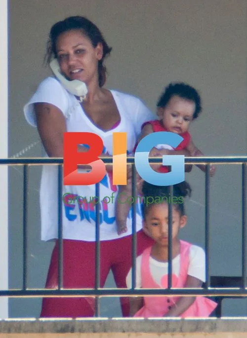 Melanie Brown with family on balcony