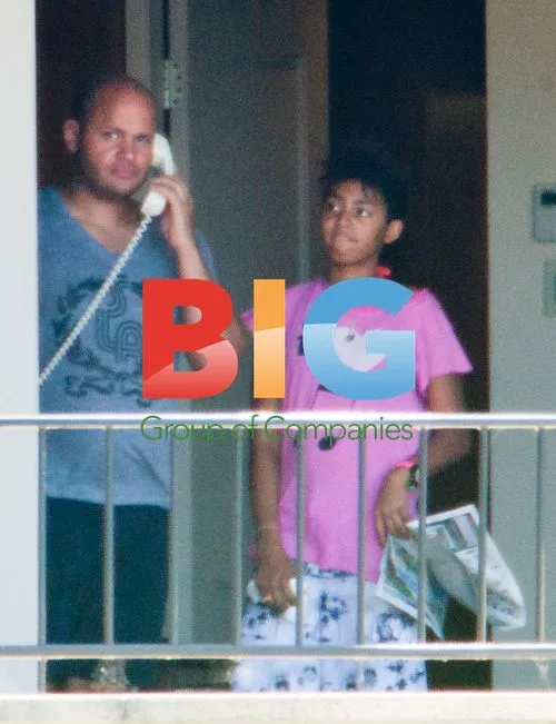 Melanie Brown with family on balcony