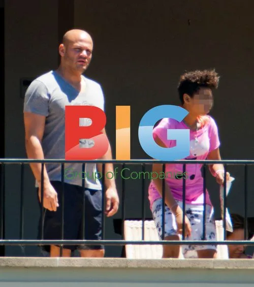 Melanie Brown with Family on Balcony