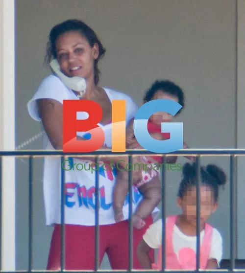 Melanie Brown with Family on Balcony