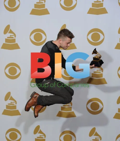 Ryan Tedder leaps with Grammy backstage
