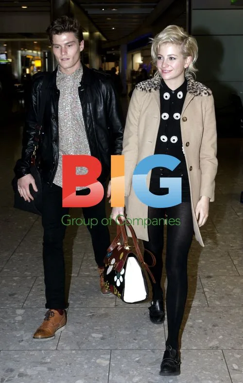 Pixie Lott and boyfriend Oliver Cheshire at Heathrow