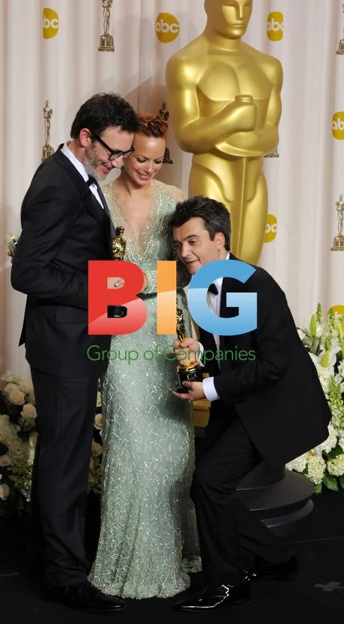 Michel Hazanavicius and Thomas Langmann hold Oscars
