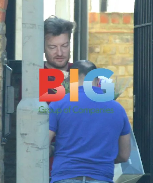 Tired-looking Dad Charlie Brooker Receives Flowers at Home