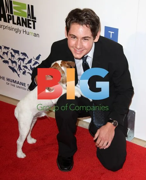 Dominic Scott Kay and Uggie the dog at The 26th Genesis Awards
