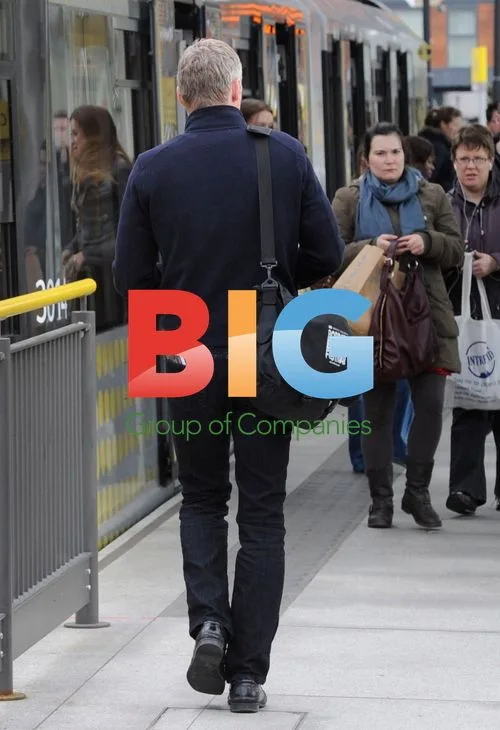 Rory Bremner taking tram in Manchester