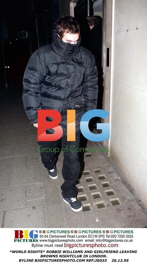 Robbie Williams and girlfriend leaving Browns