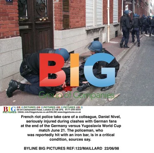 French riot police tend to injured colleague after clashes