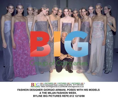 Giorgio Armani Poses with Models