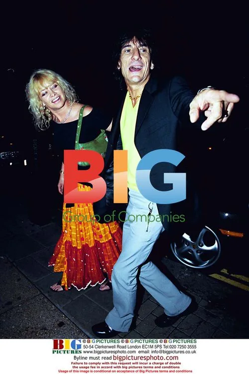 Ronnie Woods' wife drags singer away