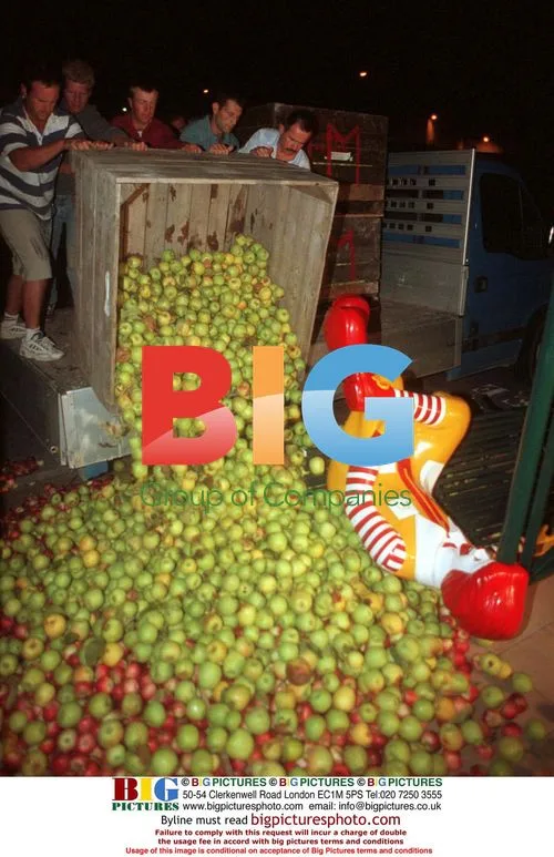 Angry French farmers dump fruit on Ronald McDonald