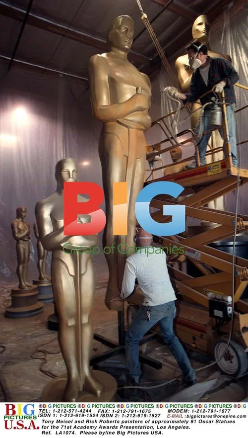 Tony Meisel and Rick Roberts painting Oscar statues