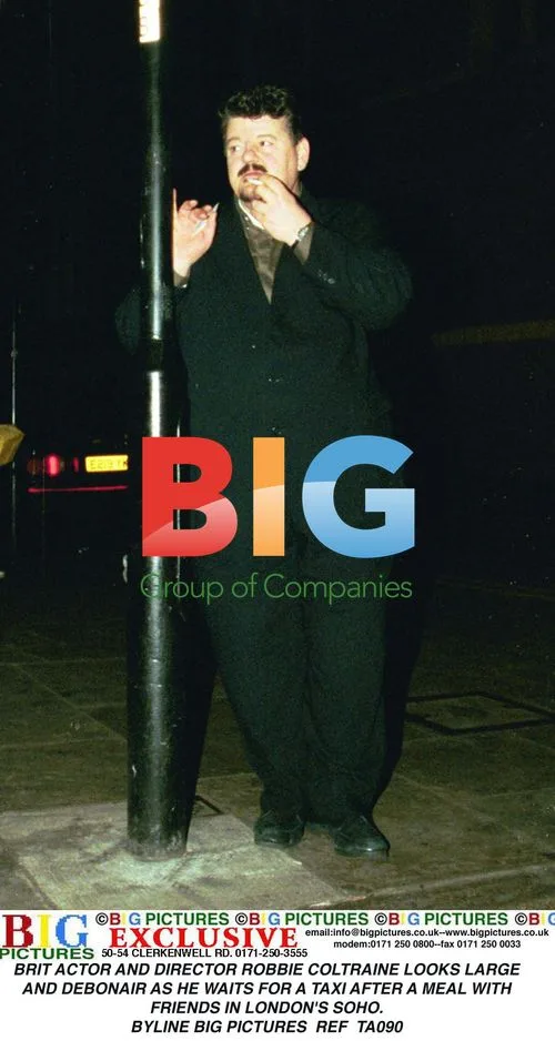 Robbie Coltraine Waits for Taxi in Soho