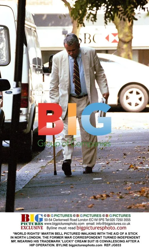 Martin Bell Walks with Cane in London