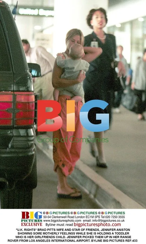 Jennifer Aniston holding toddler