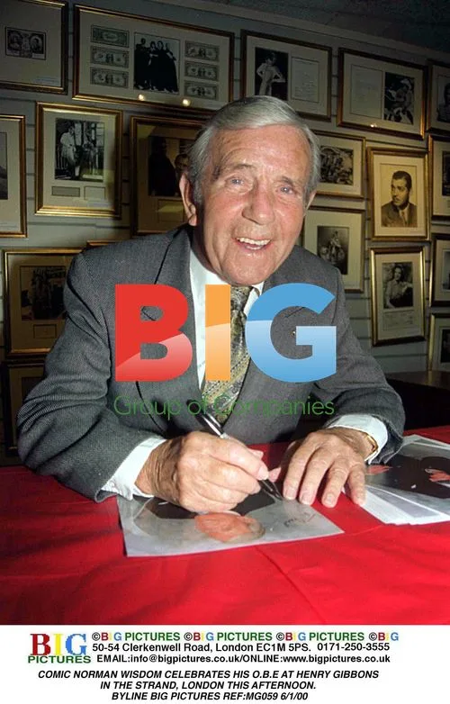 Norman Wisdom Celebrates His OBE