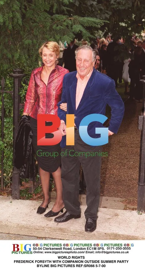 Frederick Forsyth with companion at summer party