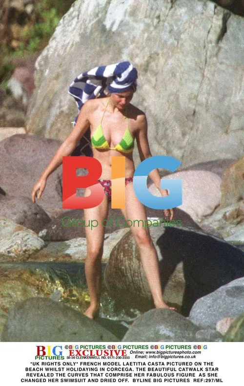 Laetitia Casta Relaxes on Beach in Corcega