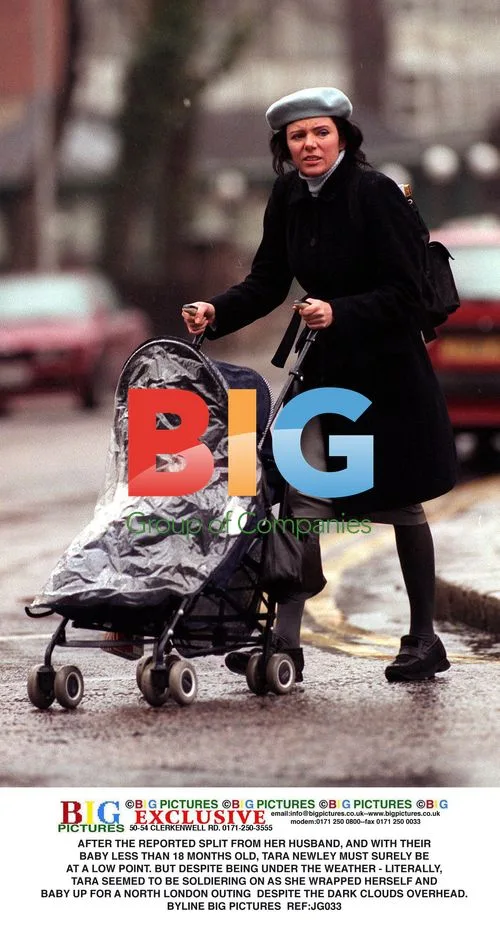 Tara Newley out with baby despite rainy day