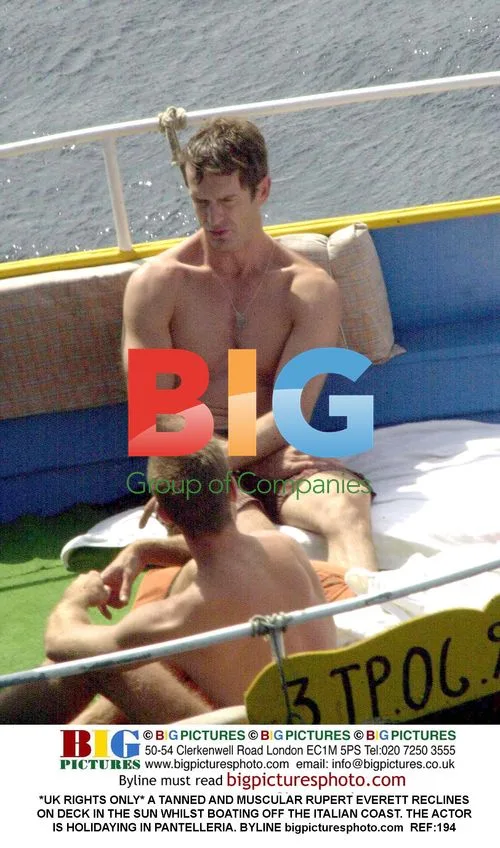 Rupert Everett Reclines Shirtless on Boat