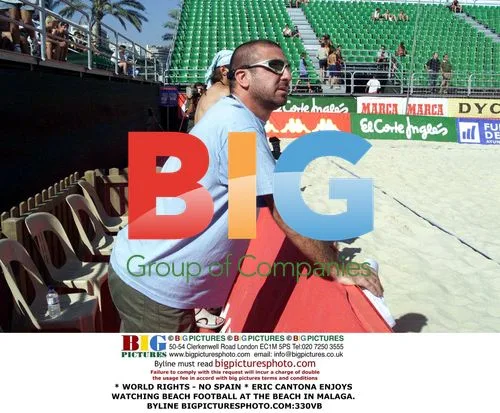Eric Cantona watches beach football in Malaga