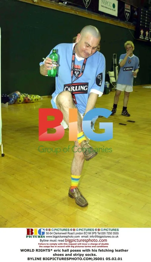Eric Hall poses in leather shoes and stripy socks