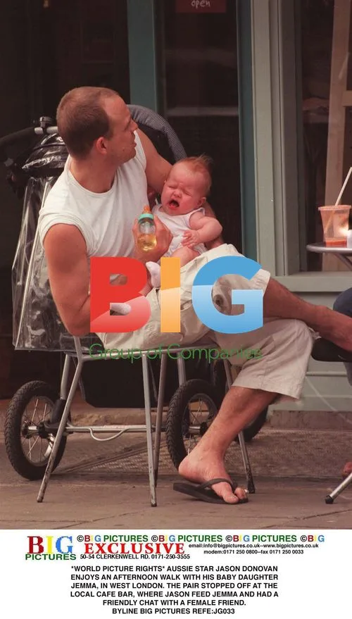 Jason Donovan and baby daughter Jemma in London