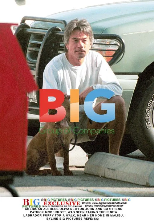 Oliva Newton John and Boyfriend Walk Puppy