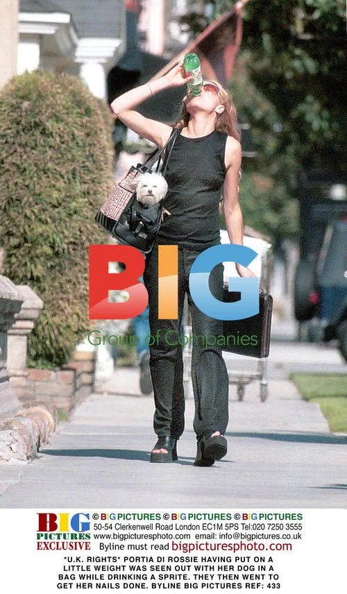 Portia Di Rossie Walks Dog While Drinking Sprite