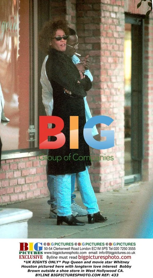 Whitney Houston and Bobby Brown outside shoe store