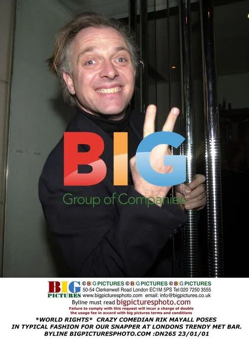 Comedian Rik Mayall poses in London