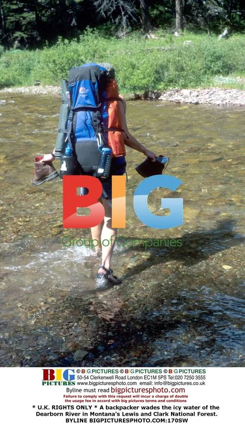 Hiker wades through icy Montana river