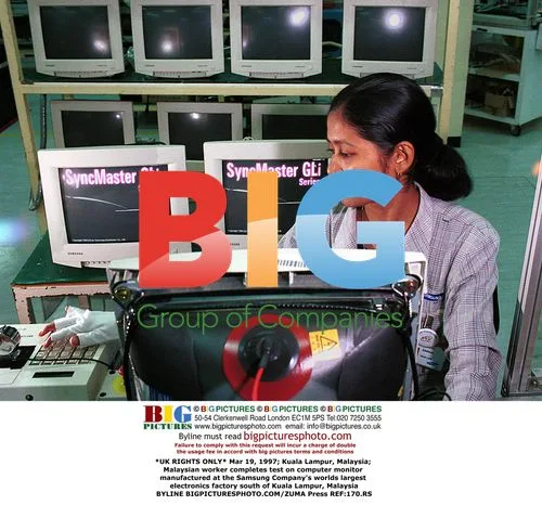 Malaysian worker tests computer monitor