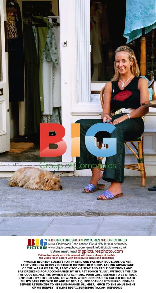 Lady Victoria Hervey with dog Zulu outside her shop