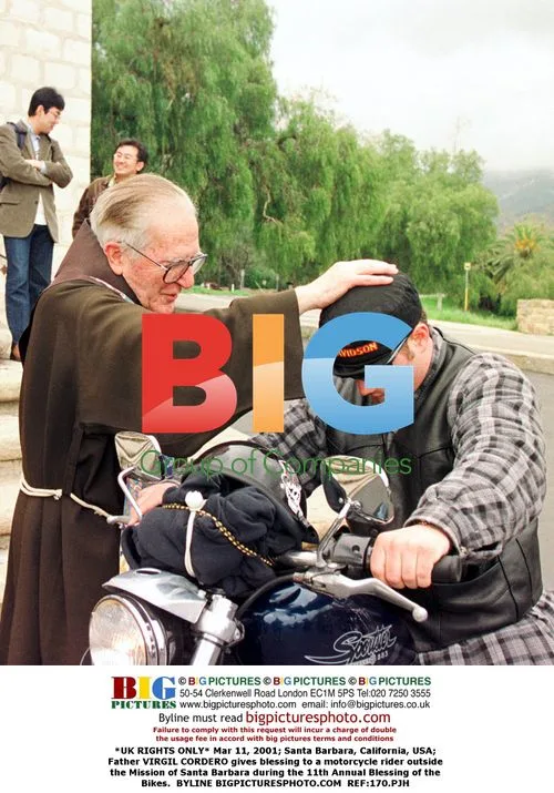 Priest Blesses Motorcycle Rider at Bike Blessing