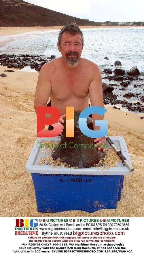 Archaeologist with Bronze Bell from Sunken Ship