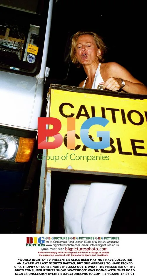 Alice Beer Holds Road Sign at BAFTA Awards