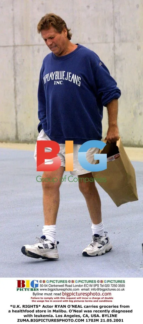 Ryan O'Neal carries groceries in Malibu