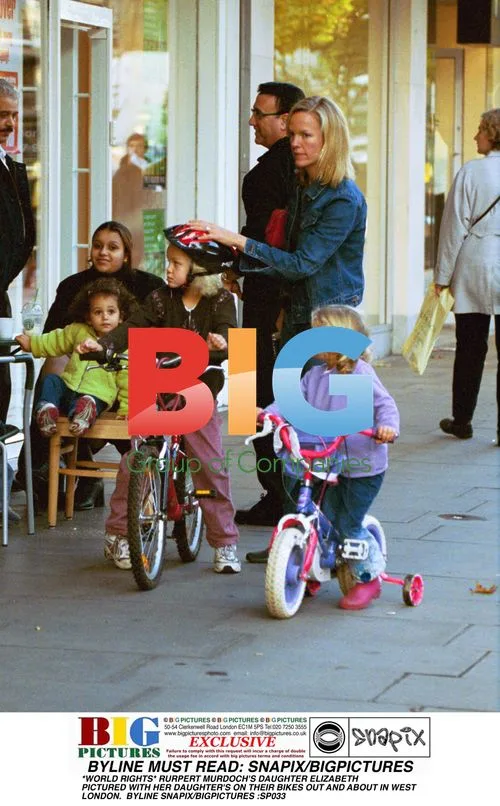 ELIZABETH MURDOCH AND DAUGHTERS BIKE IN LONDON