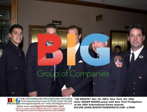 Roger Moore Poses with NY Firefighters at Emmy Awards
