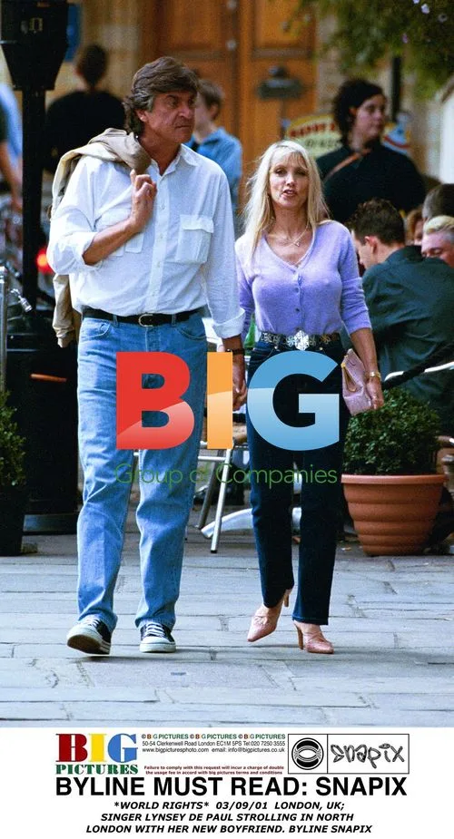 Lynsey de Paul strolls with boyfriend in London